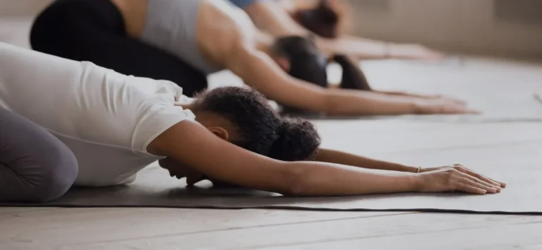 Women in child's pose. How to become a pilates instructor